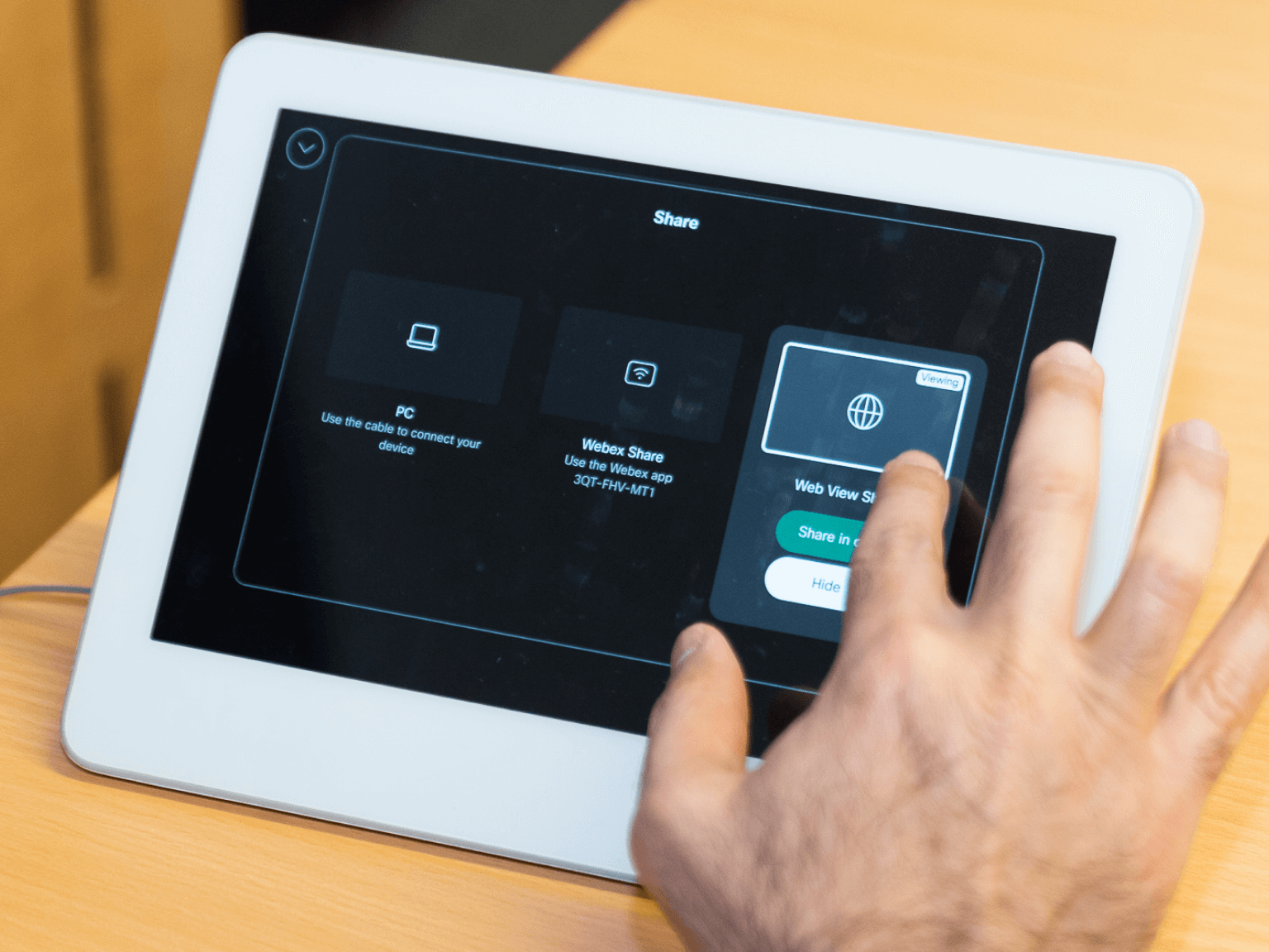 Hand interacting with a tablet screen displaying sharing options including PC connection, Webex Share, and Web View Share.